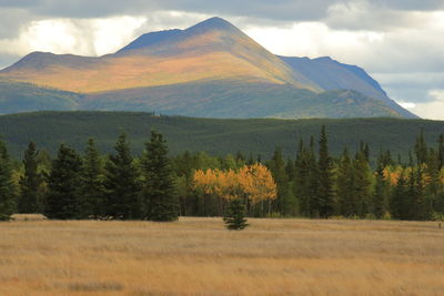 Scenic view of mountains against cloudy sky