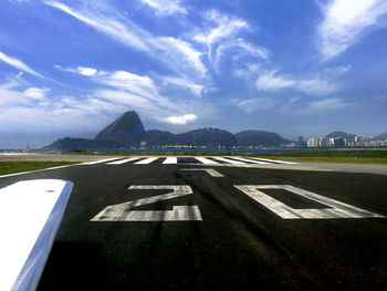 Airplane on road against sky