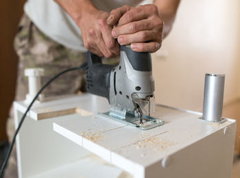 Midsection of man working in kitchen