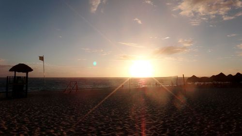 Scenic view of beach against sky during sunset