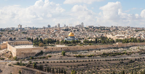 Panoramic view of buildings in city against sky