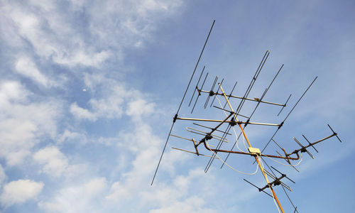 Low angle view of telephone pole against sky