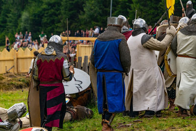 Rear view of people on field