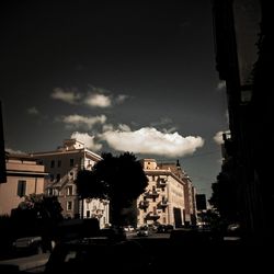 Buildings against cloudy sky