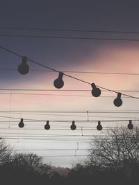 Low angle view of power lines against sky