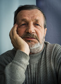 Close-up portrait of sad man at home