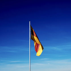 Flag against blue sky ...