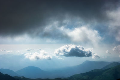 Low angle view of mountains against dramatic sky