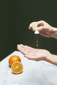 Young woman taking serum on hand