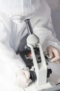 Research scientist using a microscope in a laboratory, concept science and technology.