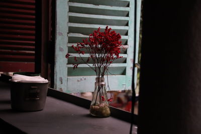 Close-up of flower vase on table at home