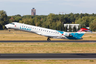 Airplane on runway against sky