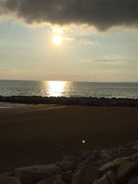 Scenic view of beach against sky during sunset