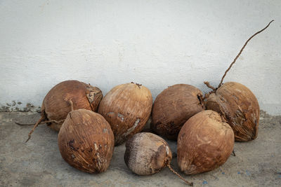 Close-up of fruits on table against wall