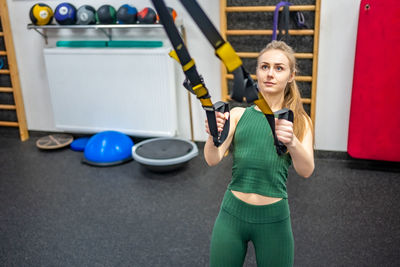 Young woman exercising in gym