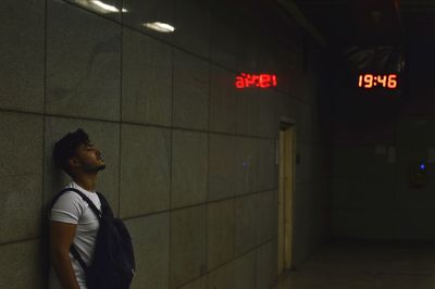 Man standing in illuminated room