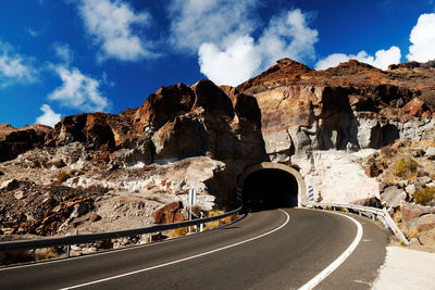 Empty road leading towards tunnel at gran canaria island