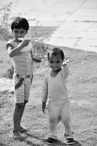 Portrait of happy girl playing on field