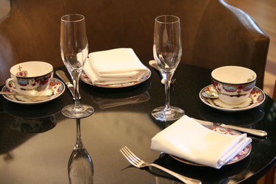 Close-up of wine glasses on dining table