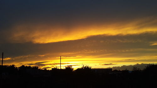 Silhouette of trees against sky during sunset