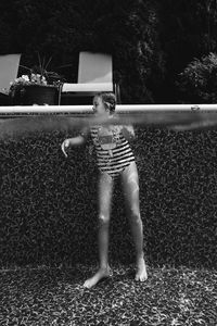 Rear view of boy playing with umbrella