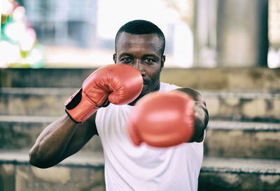 Portrait of man wearing boxing glove