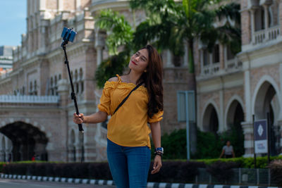 Full length of woman standing in city