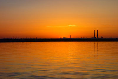 Scenic view of sea against romantic sky at sunset