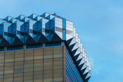 Low angle view of modern building against clear blue sky