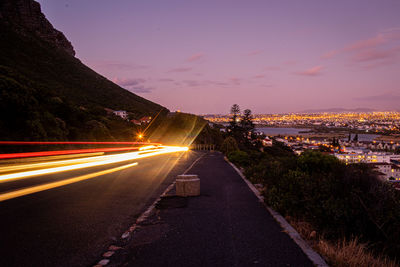 High angle view of light trails on road against sky during sunset