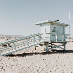 Lifeguard hut on beach against clear sky