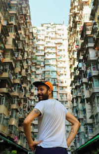 Rear view of man standing in hong kong monster building