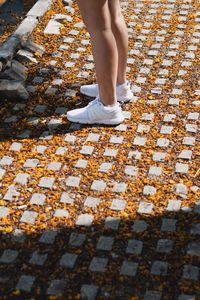 Low section of woman standing on street