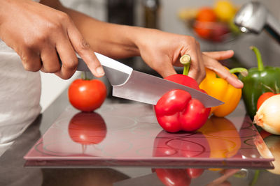 Midsection of man preparing food in kitchen at home