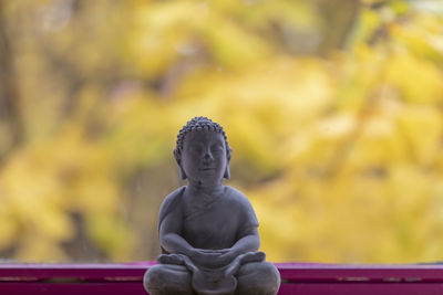 Statue of buddha against blurred background