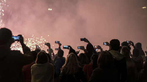 Rear view of people enjoying at music concert