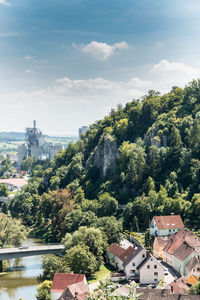 High angle view of trees and buildings against sky