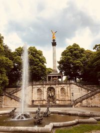 Statue of fountain against cloudy sky