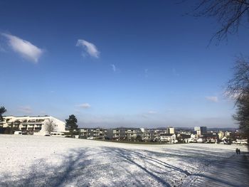 Buildings in city against sky during winter