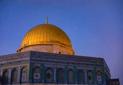 Low angle view of majidil aqsa mosque against blue sky