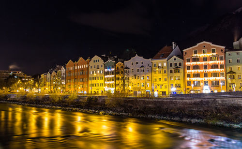 Reflection of buildings in city at night