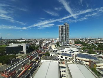 High angle view of street amidst buildings against sky