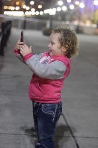 Full length of toddler using mobile phone