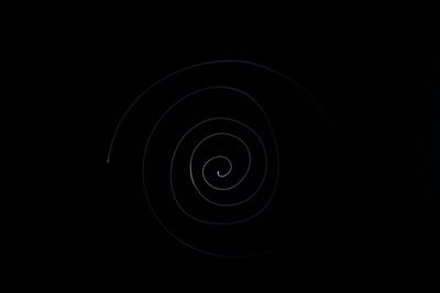 Close-up of light bulb over black background