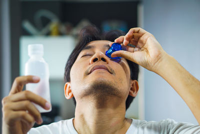 Portrait of man holding bottle
