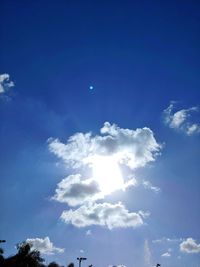 Low angle view of moon in blue sky