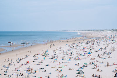 High angle view of people on beach against sky