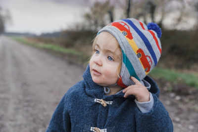 Close-up of cute girl looking away in park