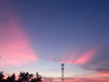 Low angle view of tower against sky at sunset