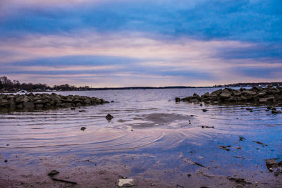 Scenic view of lake at sunset